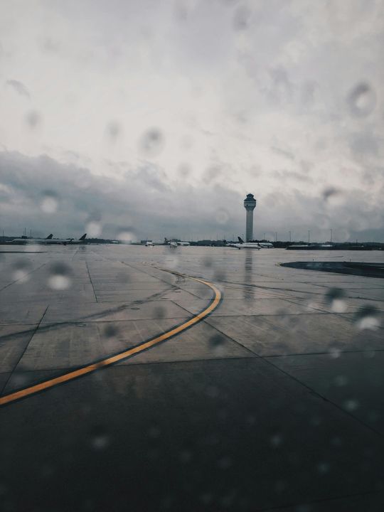 Nhìn ra ngoài đường băng, ông thấy gió lớn và mưa giông đang thổi không ngừng bên ngoài.