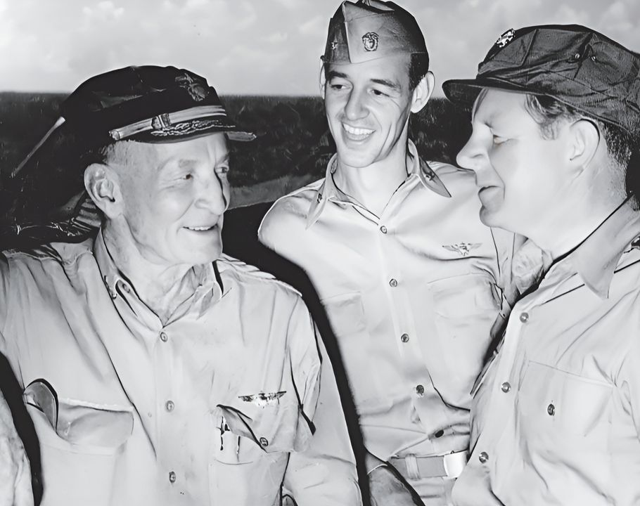 Đại tá “Jimmie” Thach, xuất hiện ở giữa bức ảnh, trên tàu sân bay USS Shangri-La (CV-38) cùng với Trợ lý Bộ trưởng Hải quân phụ trách Không quân, John Sullivan ở bên phải, và tư lệnh Lực lượng Đặc nhiệm 38, Phó Đô đốc John S. McCain, Sr., ở bên trái. Với cương vị Sĩ quan Tác chiến của TF 38, mối quan tâm chính của Thach là tìm ra cách để đánh bại mối đe dọa kamikaze, điều mà công nghệ thời đó đã chứng minh là bất khả thi. (NARA)