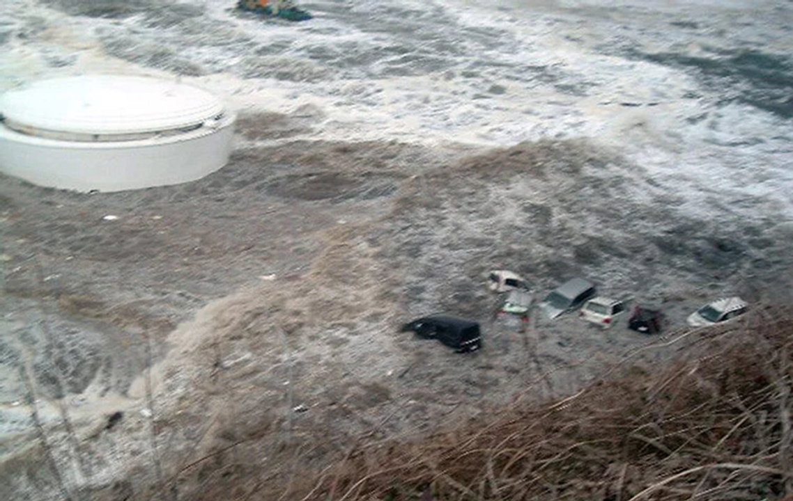 Sóng quăng quật xe như những món đồ chơi. Ảnh: The Guardian/AP 