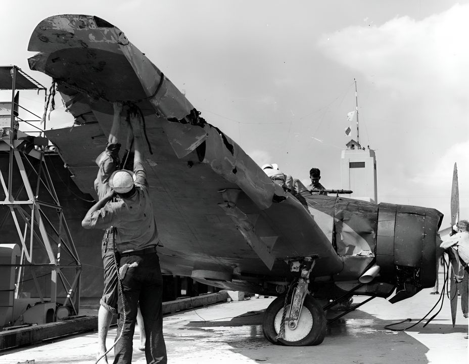 Máy bay  Type 99 (Val) từ tàu sân bay Kaga  được nhân viên Hải quân Mỹ kiểm tra khi được trục vớt từ Trân Châu Cảng ngay sau cuộc tấn công. Chiếc máy bay này tương đối nguyên vẹn, ngoại trừ phần đuôi bị gãy. (NHHC)