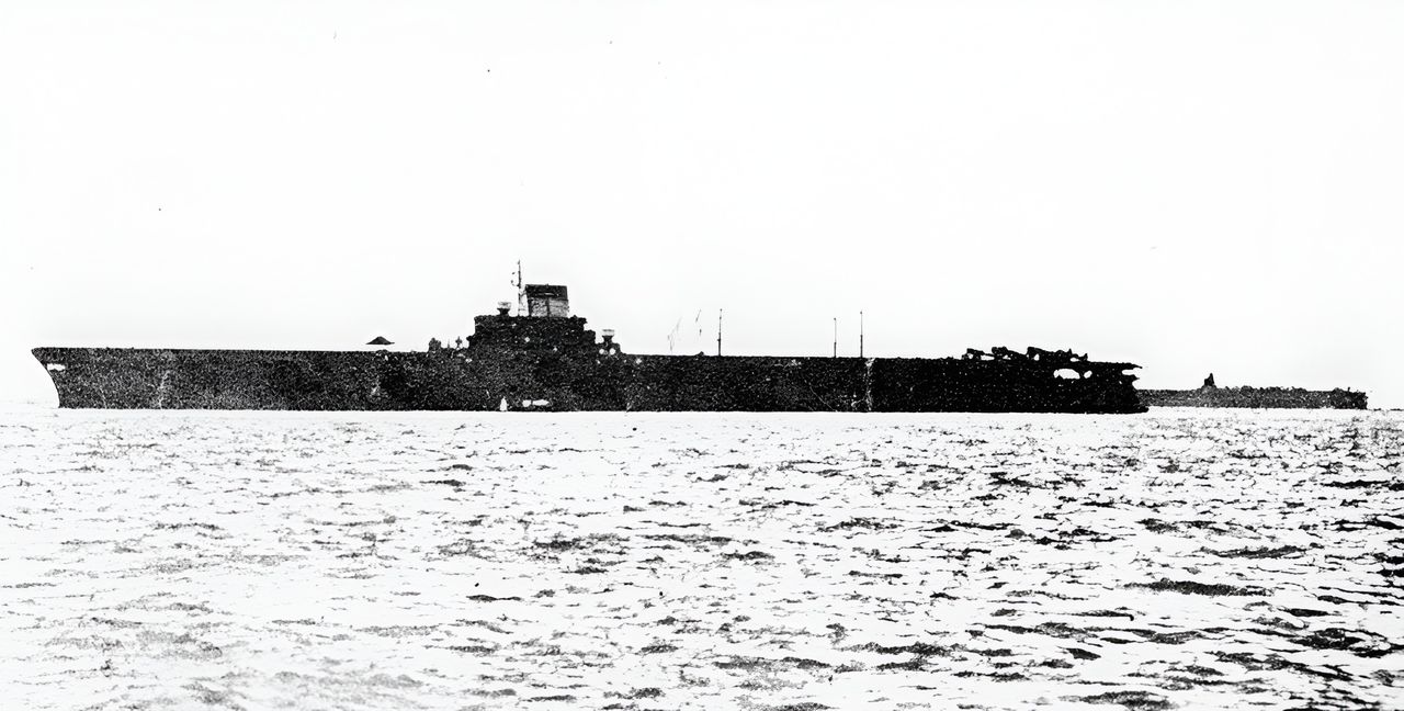 Được biên chế vào tháng 3 năm 1944, tàu sân bay Taihō là thiết kế tốt nhất của Nhật Bản trong chiến tranh, nhưng quá phức tạp để sản xuất hàng loạt — chỉ một chiếc duy nhất được hoàn thành. Với lượng giãn nước đầy tải gần 37.000 tấn, Taihō có boong bay bọc giáp dày 3,75 inch và mang được một không đoàn lớn. Bức ảnh tháng 5 năm 1944 cho thấy mũi tàu kín kiểu “hurricane bow” và cấu trúc thượng tầng lớn với ống khói nghiêng; phía bên phải có thể thấy Shokaku hoặc Zuikaku. (Yamato Museum)