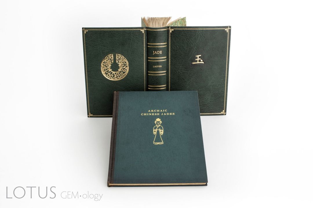Hai tác phẩm chính của Berthold Laufer về ngọc bích. Cuốn sách đầu tiên, Ngọc bích: Một nghiên cứu về khảo cổ học và tôn giáo Trung Quốc , ban đầu được xuất bản với bìa cứng khá bình thường. Tác giả Richard Hughes đã cho đóng lại bìa sách của mình tại xưởng đóng sách Green Dragon ở Massachusetts. Bìa da dê Ma-rốc màu xanh lá cây được thiết kế riêng có họa tiết từ cuốn sách. Một bìa sách tinh xảo như vậy thực sự là độc nhất vô nhị, làm cho cuốn sách càng thêm giá trị. Bên dưới là một bản sao cuốn Ngọc bích cổ Trung Quốc được sưu tầm ở Trung Quốc của Laufer do AW Bahr xuất bản . Ảnh: Pinyo Khongsawad/Lotus Gemology Co. Ltd.