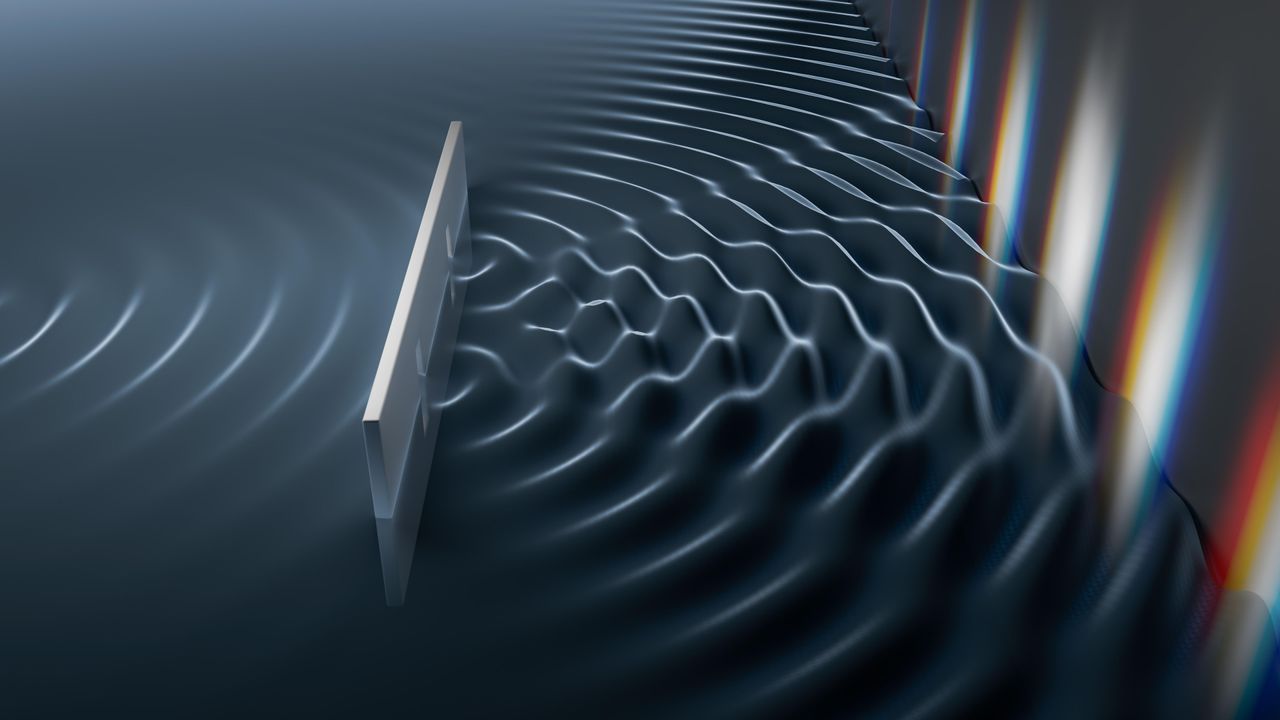 Hình&nbsp;1: Một minh họa về cách thức một sóng hành xử khi nó va vào một vật cản có hai khe. Một sóng va vào một vách có hai khe hẹp, chia sóng làm hai sóng riêng biệt mà chúng tương tác, giao thoa với nhau tạo ra một mẫu hình gồm các đỉnh và các đáy trên tấm màn phát hiện. / Image: vchal / Alamy Stock Photo
