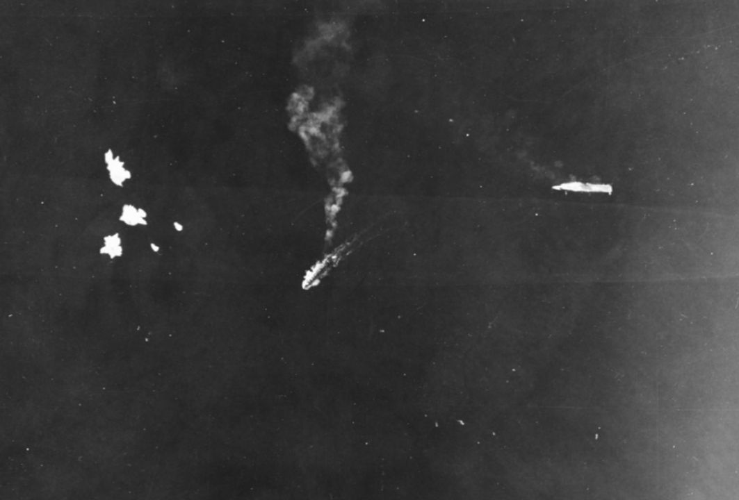 Hình ảnh tàu sân bay Ryujo của Nhật Bản bị hư hại và bất động được chụp từ máy bay ném bom B-17 của Không quân Hoa Kỳ, trong một cuộc tấn công ném bom tầm cao vào ngày 24 tháng 8 năm 1942. Một số quả bom đang phát nổ trên mặt nước, cách mũi tàu sân bay khoảng bảy chiều dài thân tàu. Giữa Ryujo và những quả bom là một tàu khu trục (có thể là Amatsukaze hoặc Tokitsukaze), trước đó đã áp sát mũi tàu sân bay bị hư hại, cứu hộ một số thủy thủ đoàn, và hiện đang lùi lại. (NHHC)