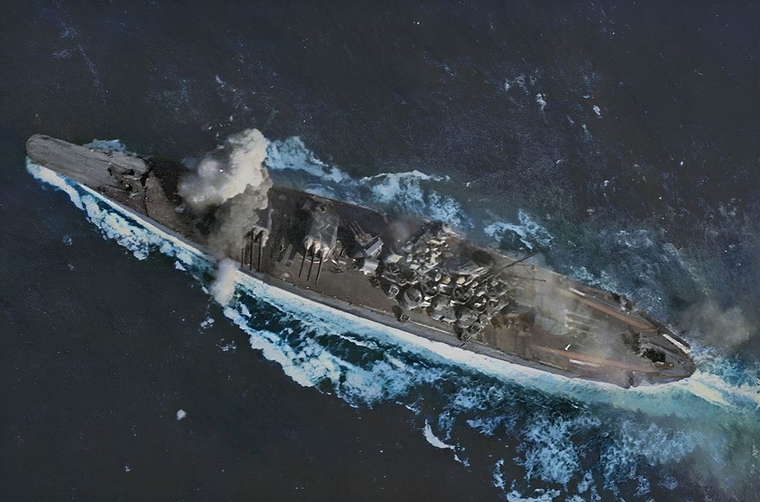 Mặc dù các không đoàn tàu sân bay tập trung tấn công vào Musashi, nhưng Yamato cũng bị tấn công và chịu thiệt hại nhẹ. Trong bức ảnh này, một trong hai quả bom 1.000 lb đánh trúng con tàu phát nổ ở phía trước Tháp pháo số 1. Chú ý khói từ các pháo 25mm và boong gỗ đã được làm đen từ trước, nhằm chuẩn bị cho khả năng thủy thủ đoàn phải giao chiến ban đêm khi đột phá qua eo biển San Bernardino. (Naval History and Heritage Command, Photo Archives, Naval Subject Collection)